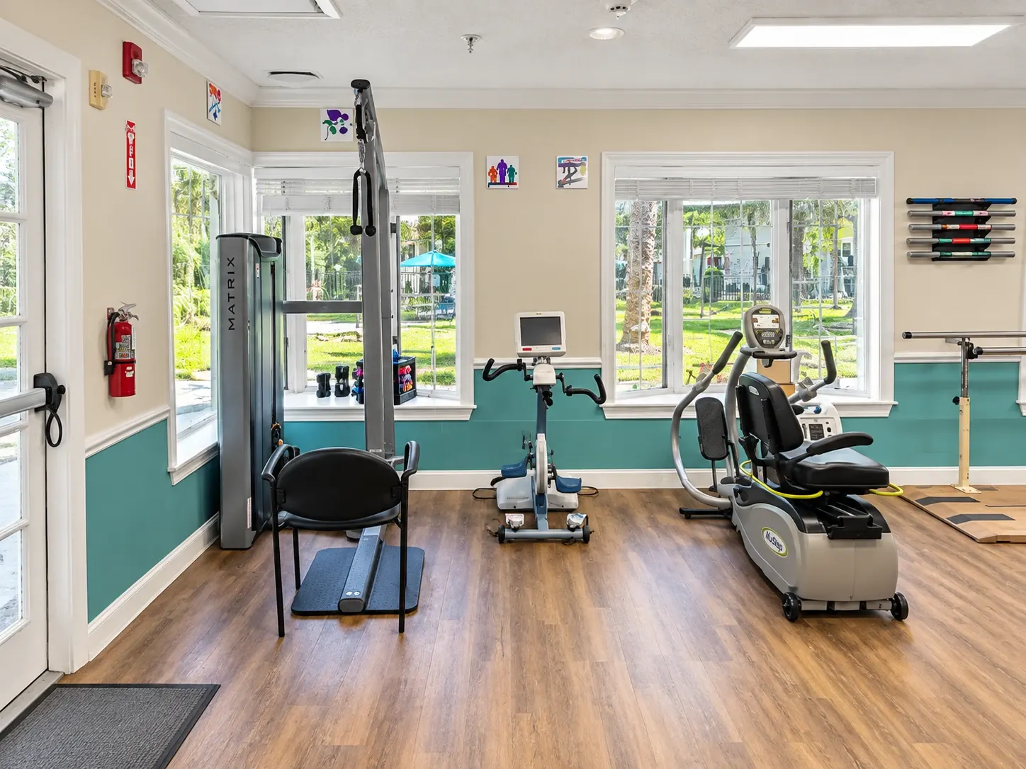 The therapy gym at Vivo Healthcare St. Petersburg, with a cable machine and exercise bikes